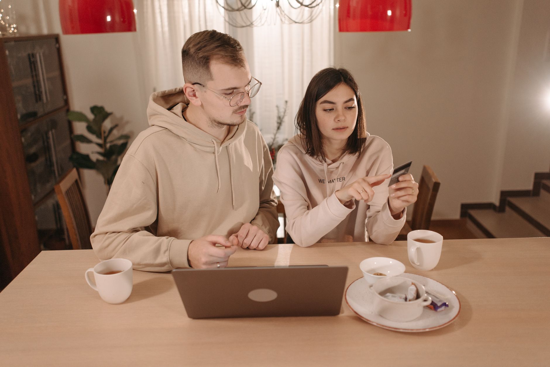 A couple enjoying online shopping with a laptop and credit card at home. Cozy indoor setting. — Photo by Pavel Danilyuk on Pexels