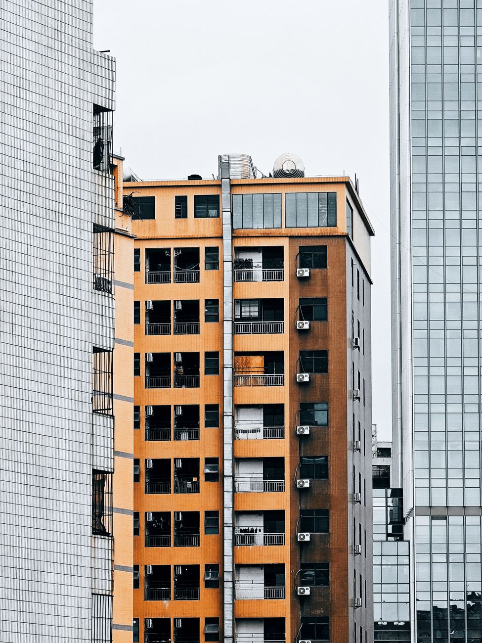 Close-up of an urban residential building exterior showcasing varied architectural elements and modern facade.