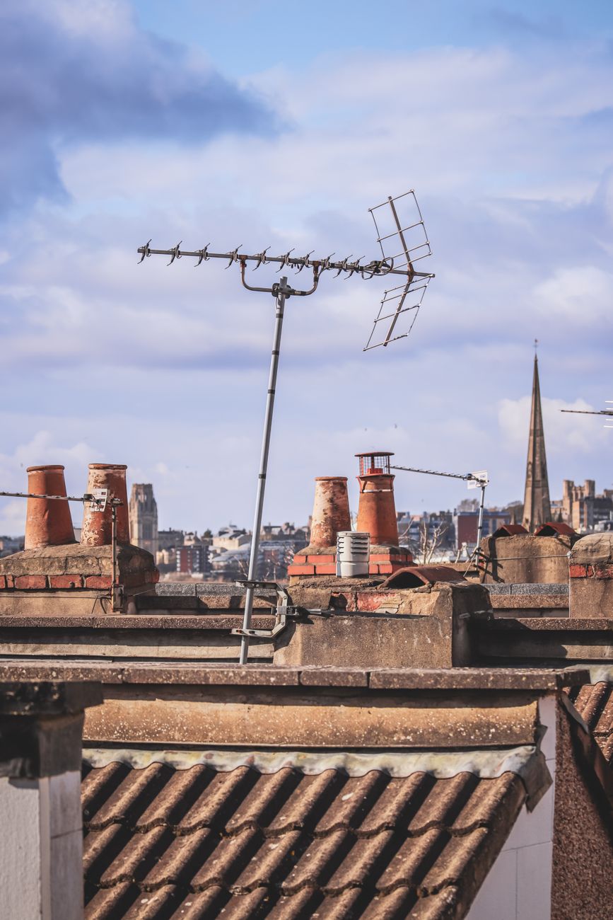 Urban rooftops featuring an antenna in Bristol, England, showcasing city charm.