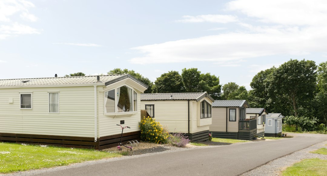 Several static caravans are parked along a road